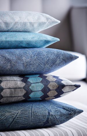 Shot of multi-colored pillows stack on ottoman stool